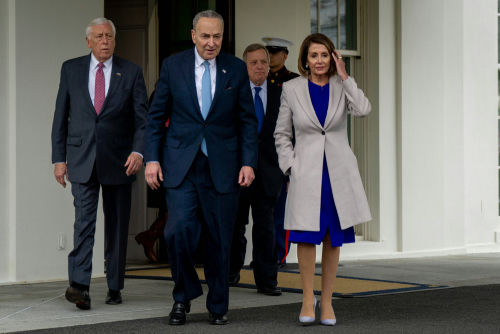 shutterstock1276349410-3jpg Group of officials walk outside a building entrance.