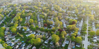 Aerial view of suburban neighborhood with tree-lined streets