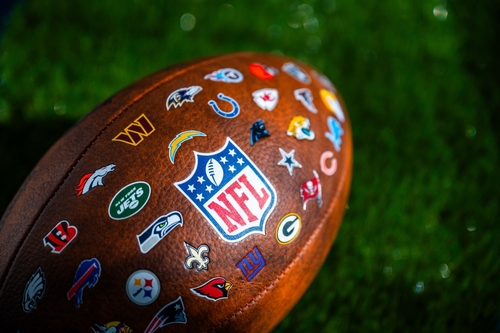 New,York,,Usa,,September,11,,2023:,Nfl,Football,Ball,,Logo Close-up of an NFL football featuring various team logos on its surface