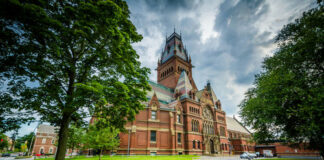 Red-brick, Gothic-style building with a prominent tower.
