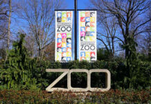 Crocodile Pit Horror Stuns Britain Smithsonians National Zoo entrance with colorful banners.