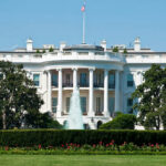 The White House with fountain and flag.