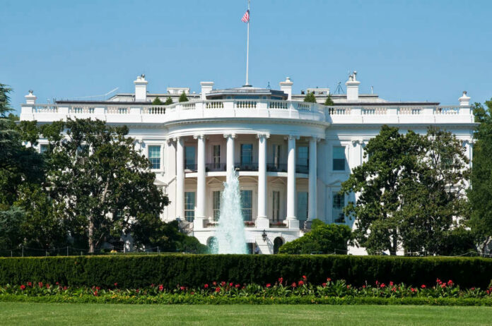 shutterstock123008023jpg The White House with fountain and flag.