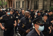 Pride Parade Ban on Armed Gay Officers Sparks Backlash Police officers gathered on a city street