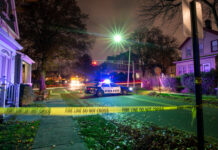 A Family Left “Violated” After Home Break-In Police car with flashing lights at a crime scene surrounded by caution tape