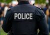 Back view of a police officer in uniform at a public event