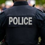 Crime Syndicates Are Expanding Across Europe Back view of a police officer in uniform at a public event