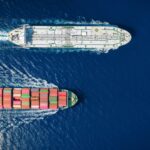 Two cargo ships navigating through the ocean