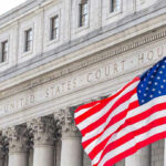 Millions Stolen, ATMs Hijacked: Foreign Crime Ring Sentenced United States courthouse with American flag waving.