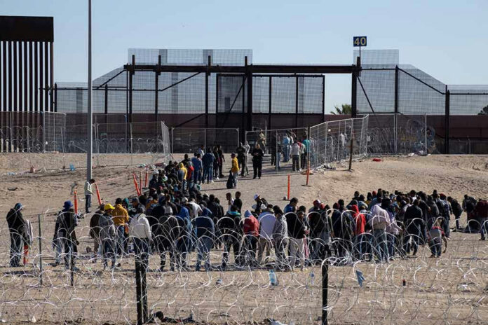2307918121 People waiting in line at border gate 40.