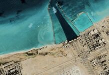Satellite view of coastal industrial complex with turquoise water