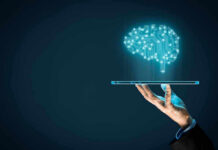 Digital brain above a hand holding a tablet.