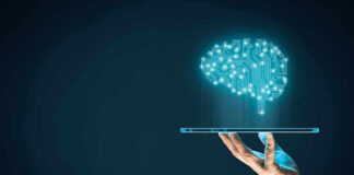 Digital brain above a hand holding a tablet.