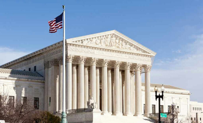 96721225-1 United States Supreme Court building with American flag.