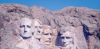 Distant view of Mount Rushmore featuring the carved faces of four U.S. presidents