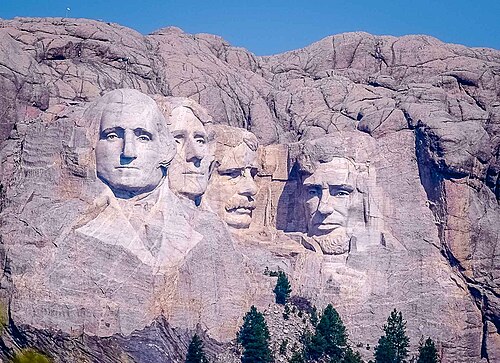 Mount_Rushmore_distant_view-1 Distant view of Mount Rushmore featuring the carved faces of four U.S. presidents