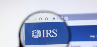 Magnifying glass over IRS website logo.