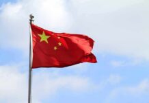 Analysts Say China’s Latest Support Ship Could Boost Carrier Operations Chinese national flag waving on a flagpole