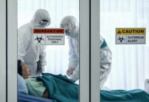London Ebola Scare: Precaution, Not Panic Healthcare workers in hazmat suits treat a patient in a quarantine room