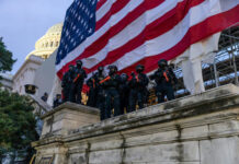 Four Proud Boys’ Jan. 6 Convictions Wiped Away Police in riot gear near U.S. Capitol building.