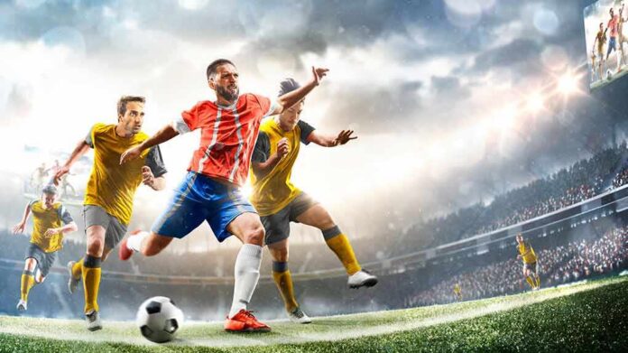 Soccer player in red jersey kicking ball during match