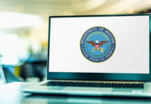 Billion Defense Bill Through Reconciliation Laptop displaying Department of Defense logo on the screen.