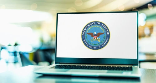 shutterstock_2082727759 Laptop displaying Department of Defense logo on the screen.