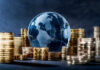 Costly Paramount Perks Surface After FCC Cleared Billion-Dollar Deal Glass globe surrounded by stacks of gold coins.