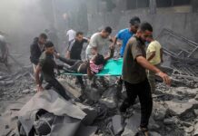 More Than 400 Killed as Pakistan Airstrike Hits Kabul Medical Facility Rescuers carry an injured person on a stretcher through rubble