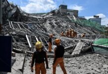 The Count Keeps Climbing But the Truth May Be Even Worse Rescue workers survey collapsed building debris