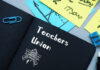 Notebook labeled Teachers Union with office supplies.