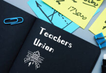 Notebook labeled Teachers Union with office supplies.