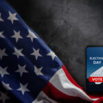 U.S. flag and phone displaying "Election Day" voting message.