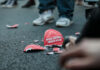 Broken Make America Great Again hat on the ground.