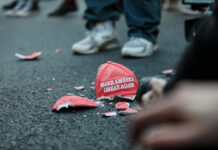 Broken Make America Great Again hat on the ground.