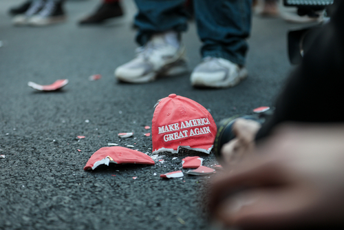 Broken Make America Great Again hat on the ground.