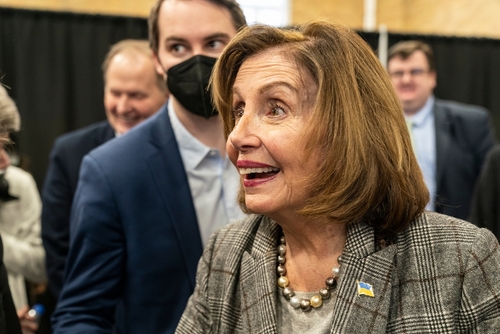 Group of people with one woman in focus, smiling.