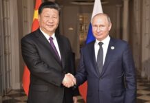 Xi Jinping and Vladimir Putin shaking hands indoors.